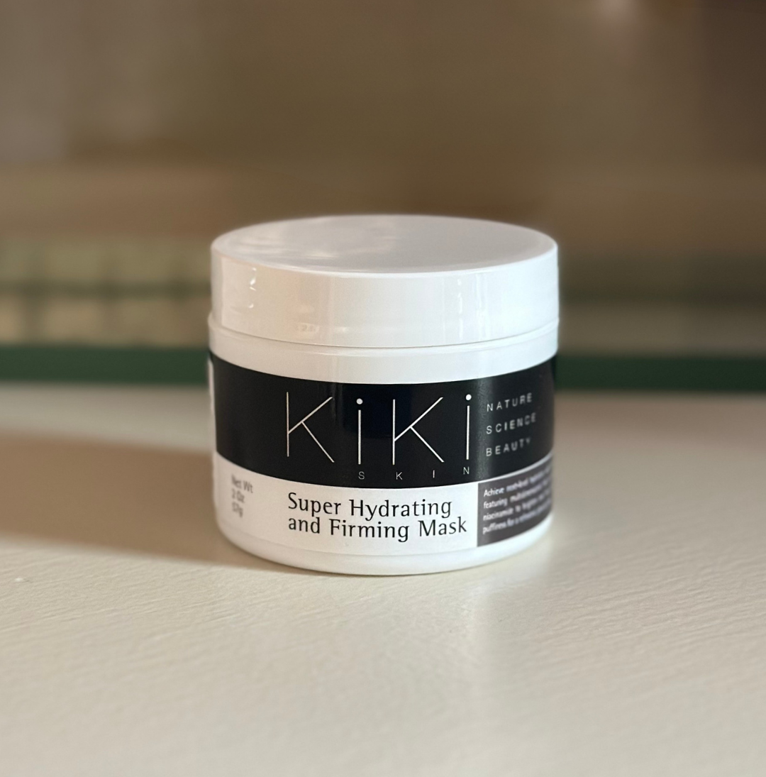Kiki Ski Super Hydrating and Firming Mask in white container with black label on wooden surface.