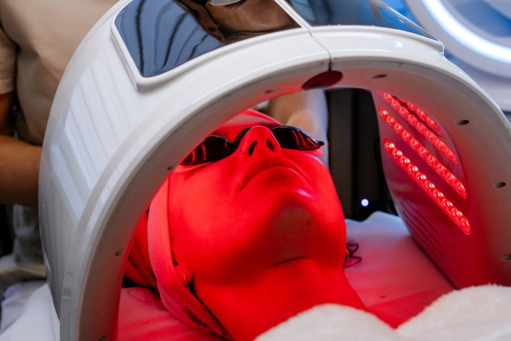 Facial Led Light Therapy Treatment In A Beauty Clinic With Red Light And Eye Protection
