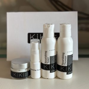 Travel size Kiki Kosmetiks products including cleanser, toner, serum, and moisturizer displayed in professional packaging.